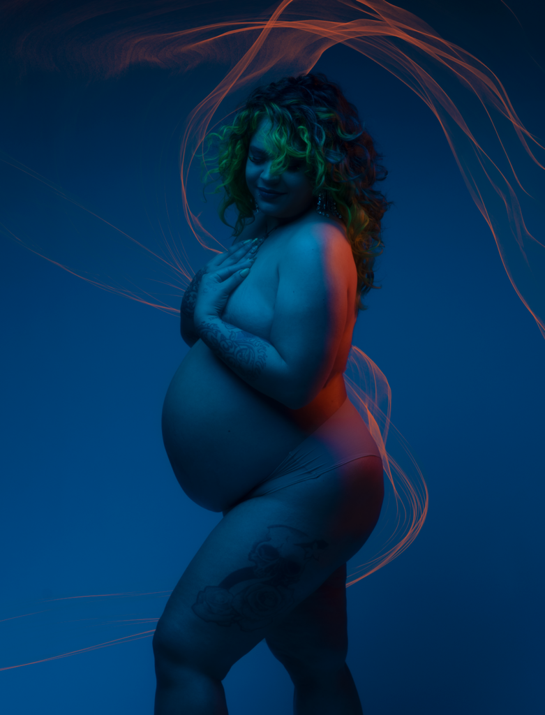 Snapzbytie Photography - Maryland Maternity Photographer - Color Gel Nude Pregnant Photoshoot - Nude Mom Draped in Color Blue and Orange Highlights