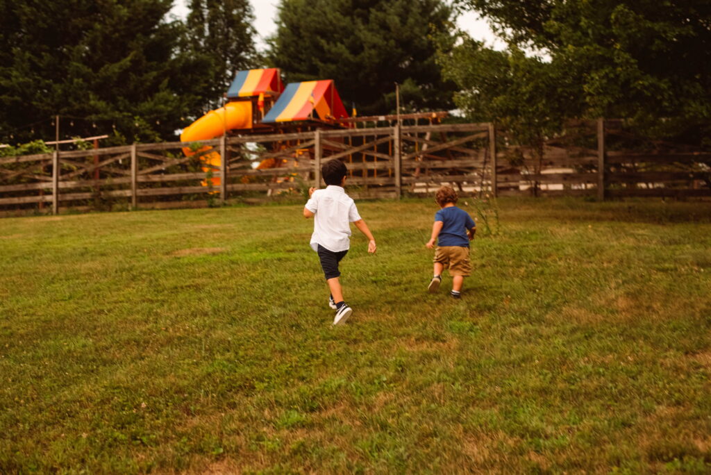 Children playing in the open field for their fall family photoshoot.