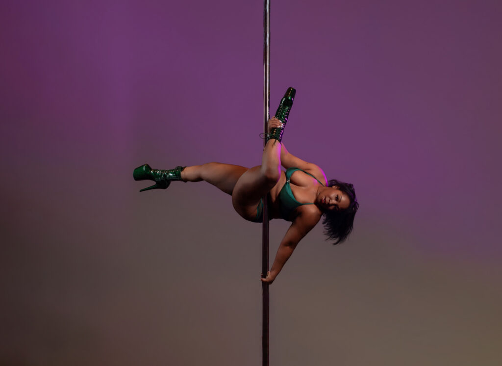 Pole Dancer Posed with purple gradient color backdrop.